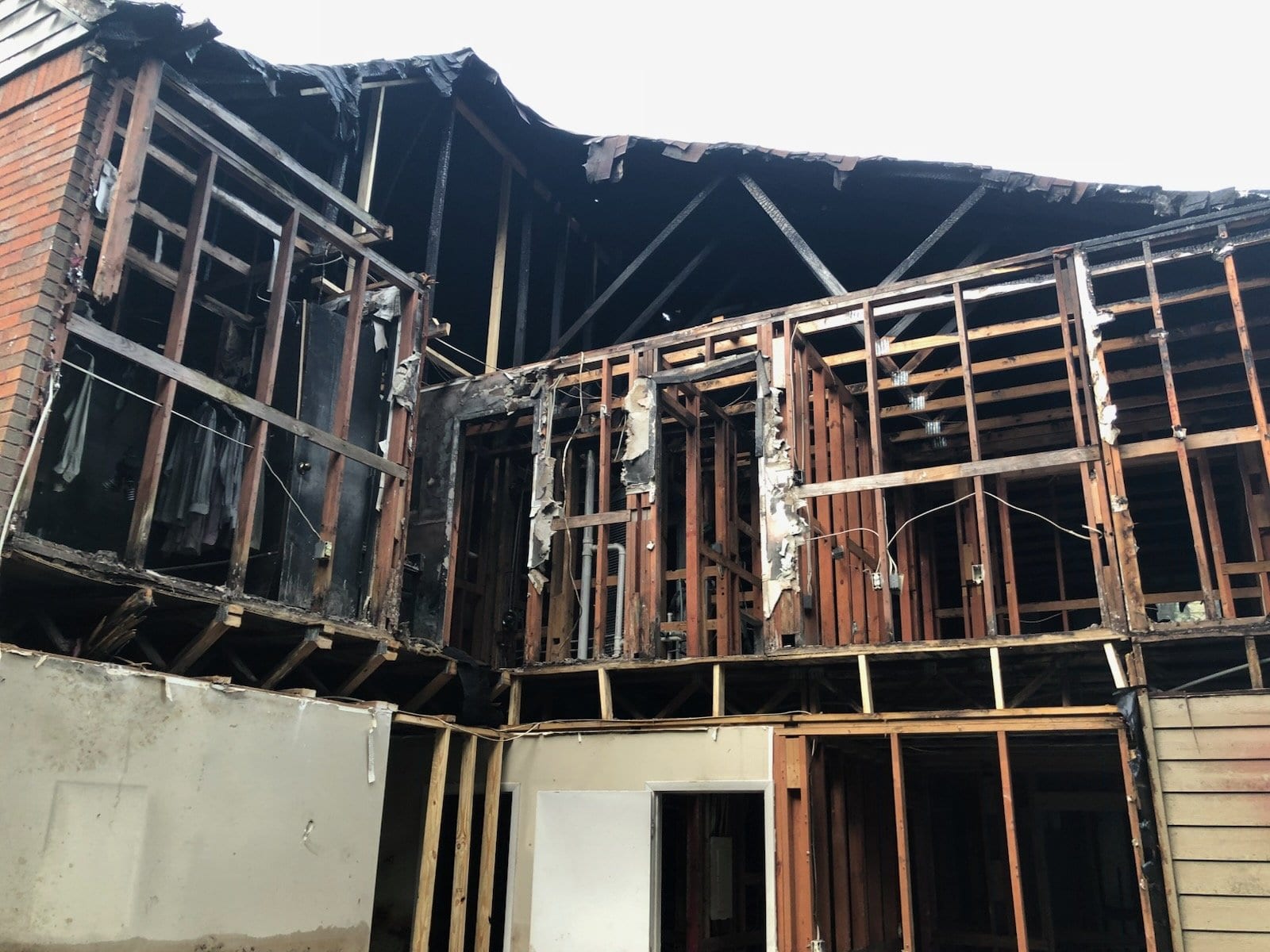 Two-storey house burned down to its charred wall and roof framing
